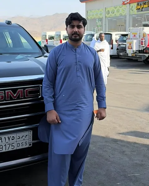 Muhammad Kamran, Al Haram Cabs driver, with a GMC Yukon